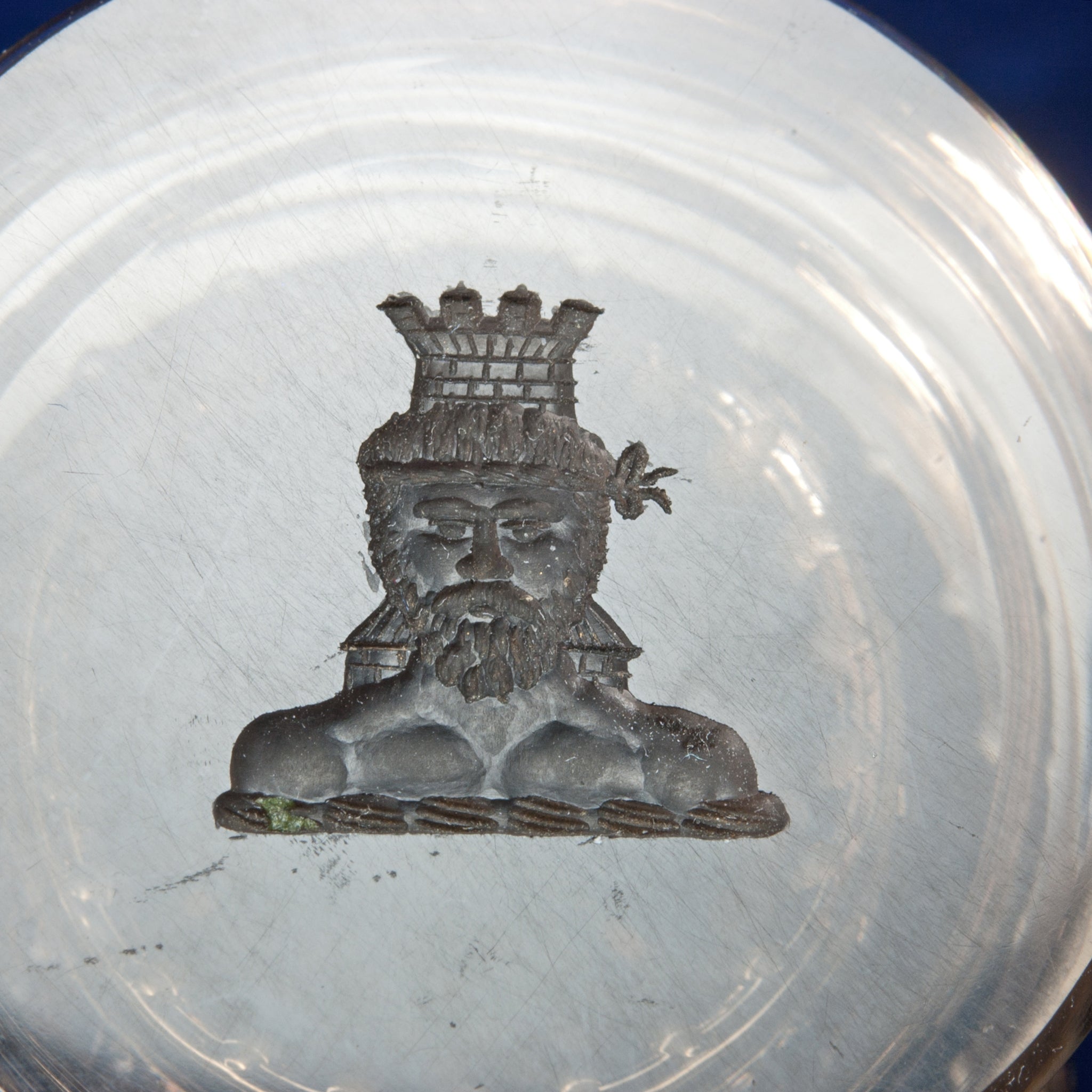 Engraving on top of wax seal showing man's head with castle tower on top