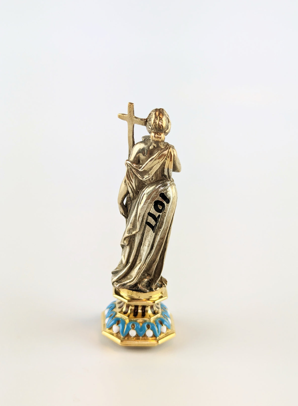 Back of full length antique silver lady holding cross wax seal