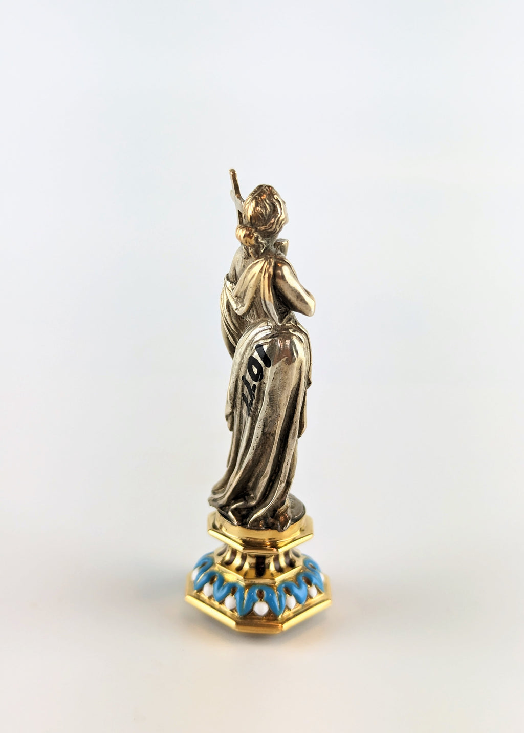 Side of antique silver lady holding cross wax seal