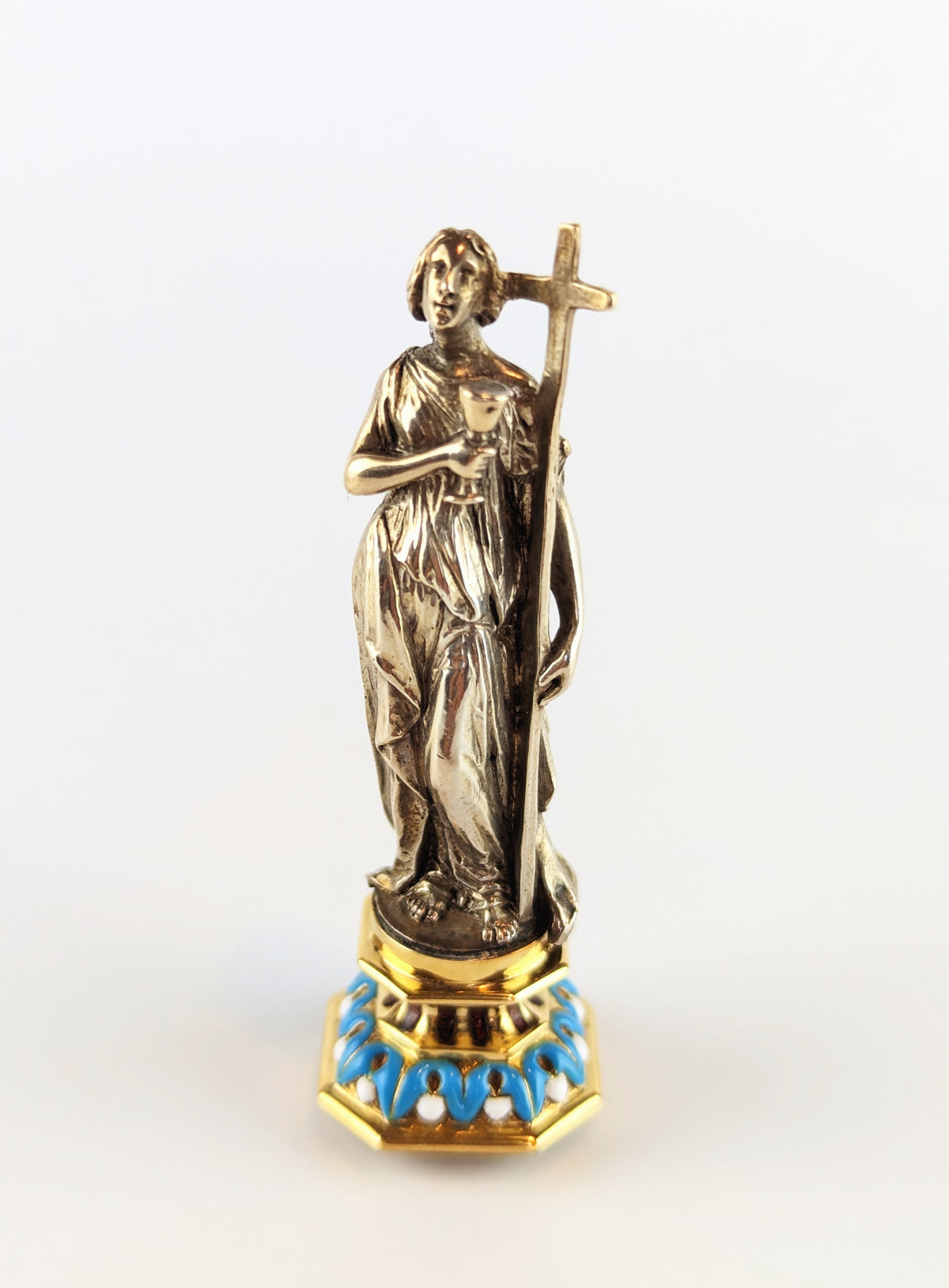 Full length of antique silver lady holding cross wax seal