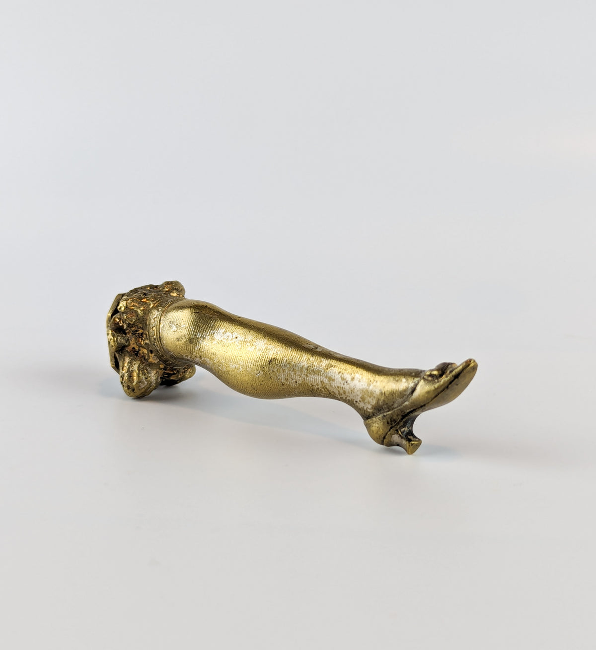 Leg and shoe on antique gilt brass wax seal