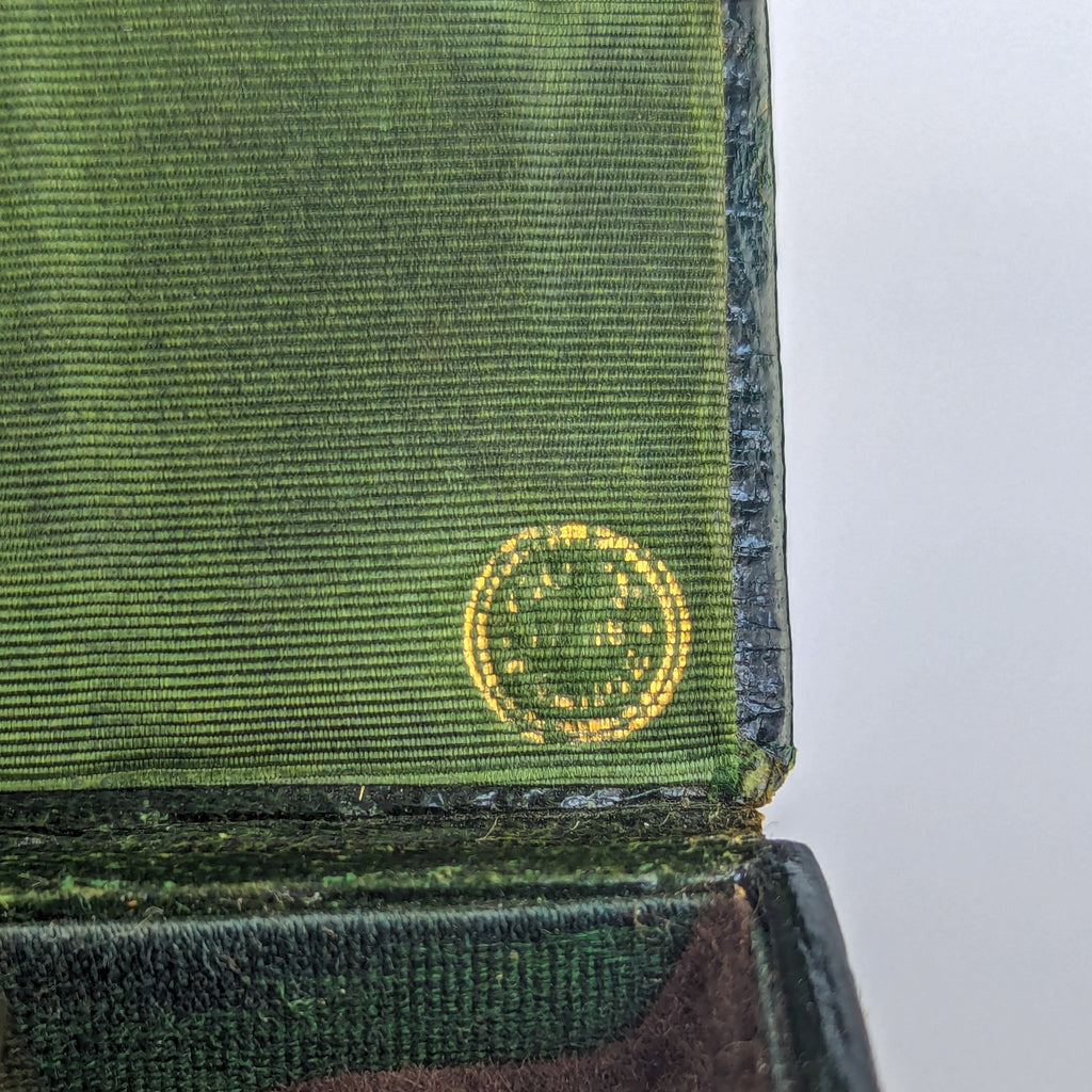 Detil of gold mark inside black leather wax seal case