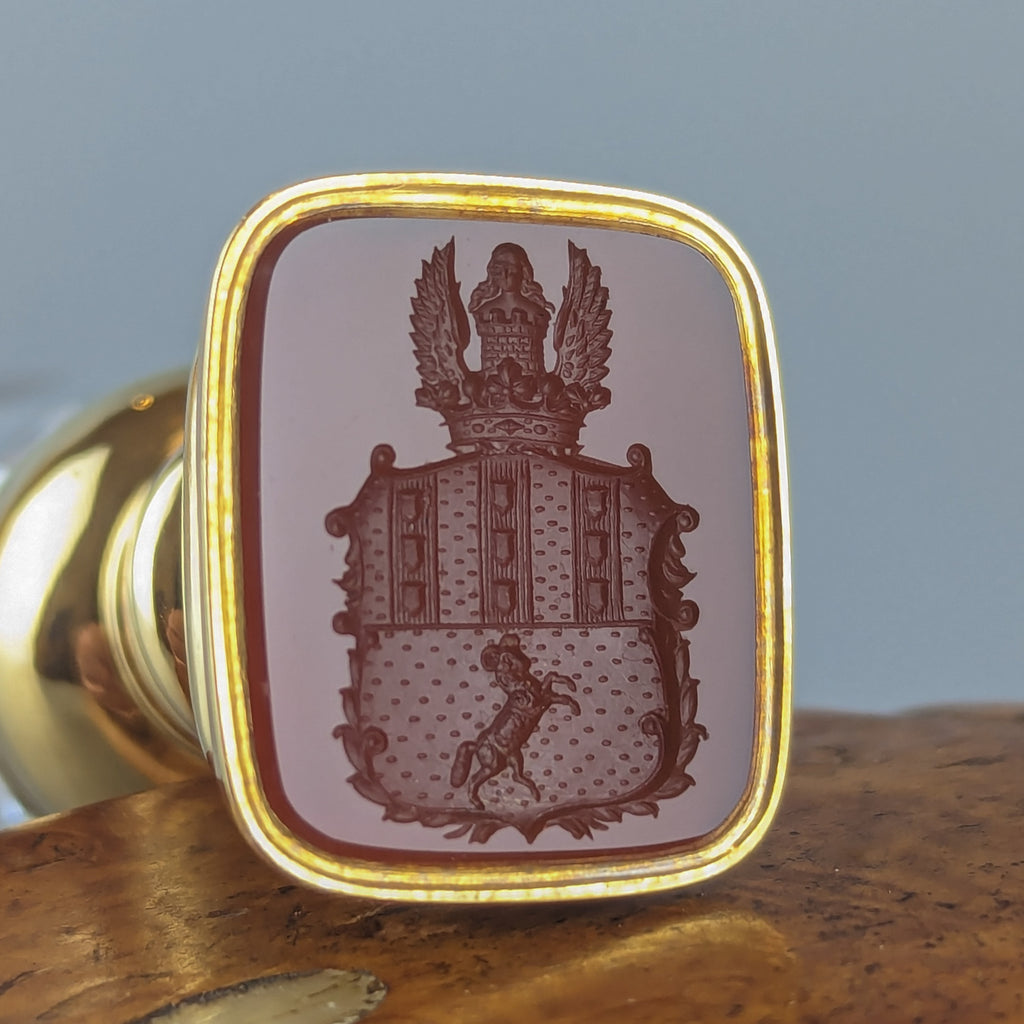 Closeup of armorial on gold and crystal antique wax seal