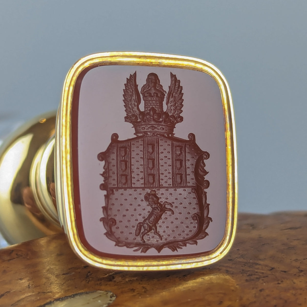Closeup of armorial on gold and crystal antique wax seal