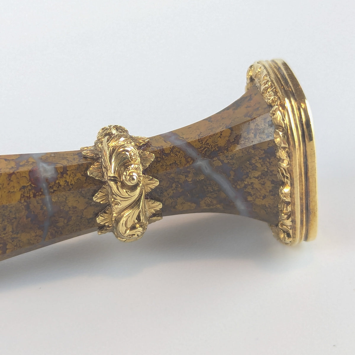 Closeup of gold and jasper wax seal stem