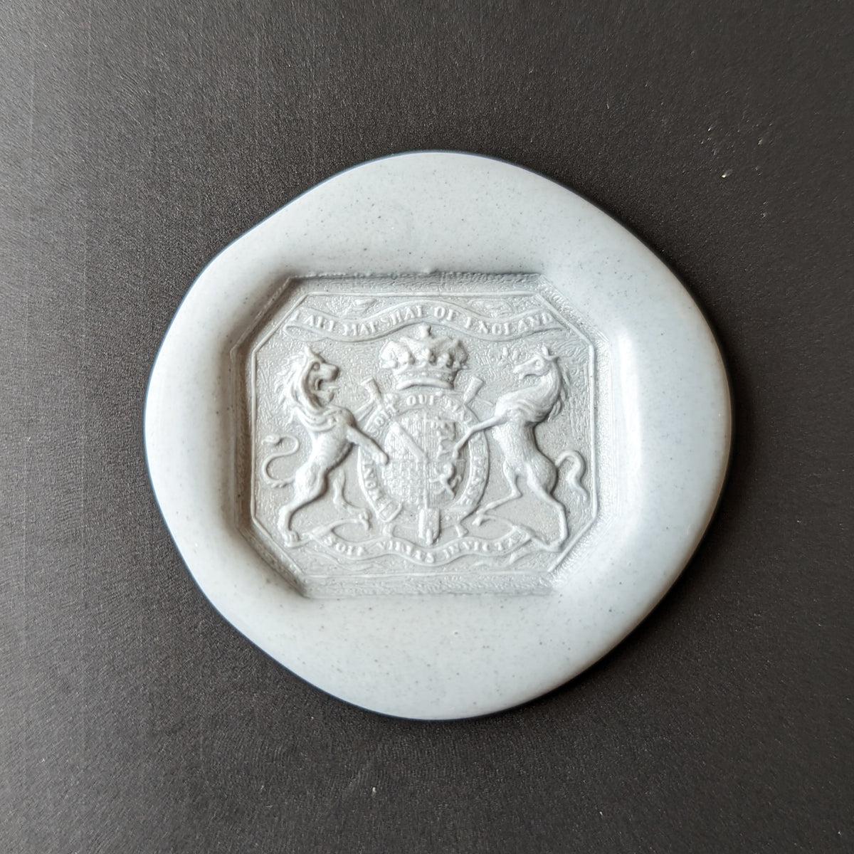 Wax impression of desk seal with armorial and motto