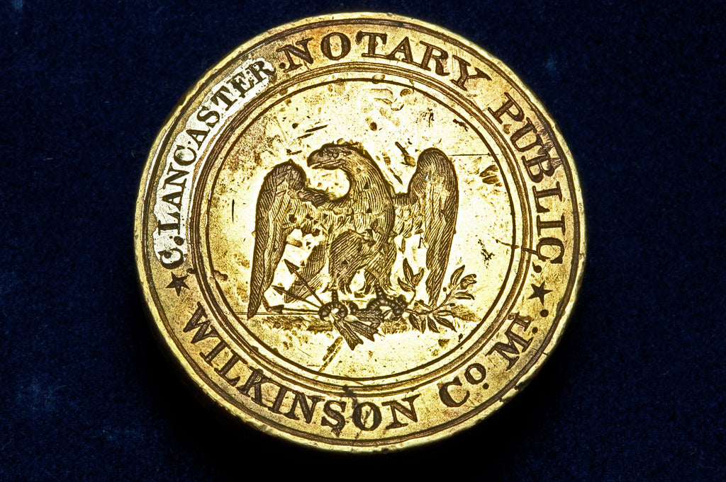 Closeup of antique wax seal matrix showing eagle and inscription