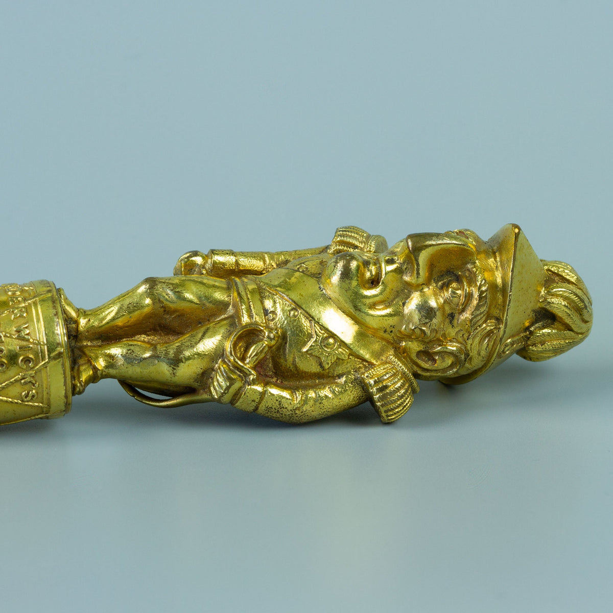 Close up of gilt wax seal figurine of Wellington in military uniform