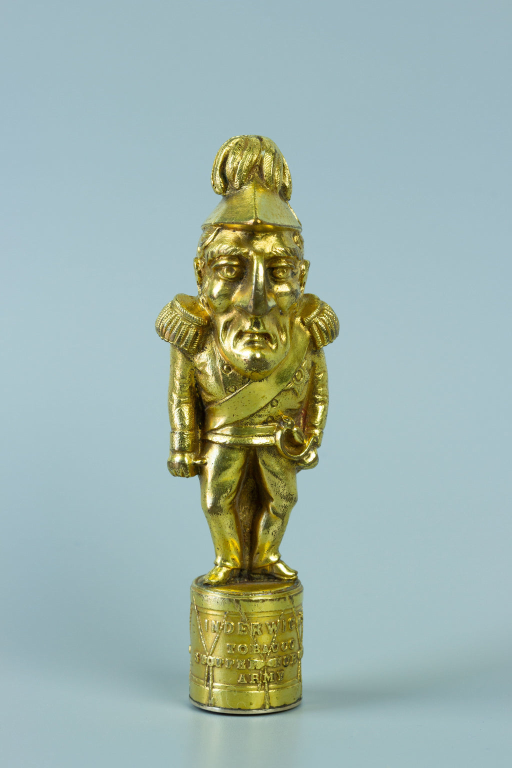 Closeup of gilt wax seal of caricature figurine of Wellington in military uniform