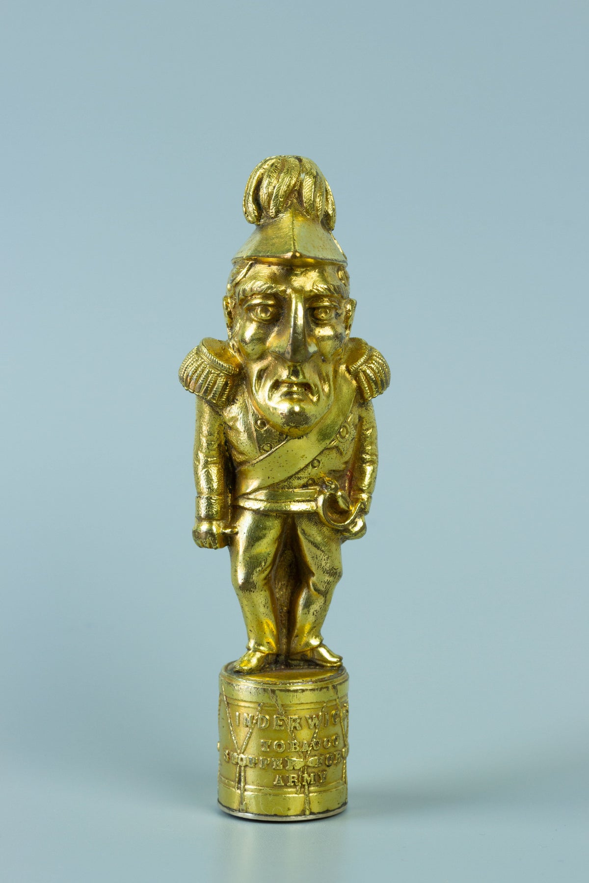 Closeup of gilt wax seal of caricature figurine of Wellington in military uniform