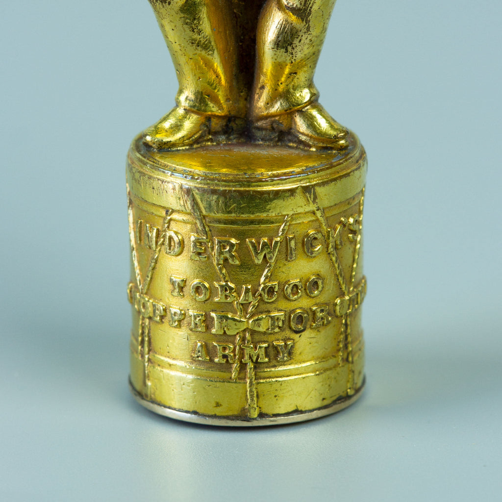Closeup of gilt wax seal base in the form of a drum 