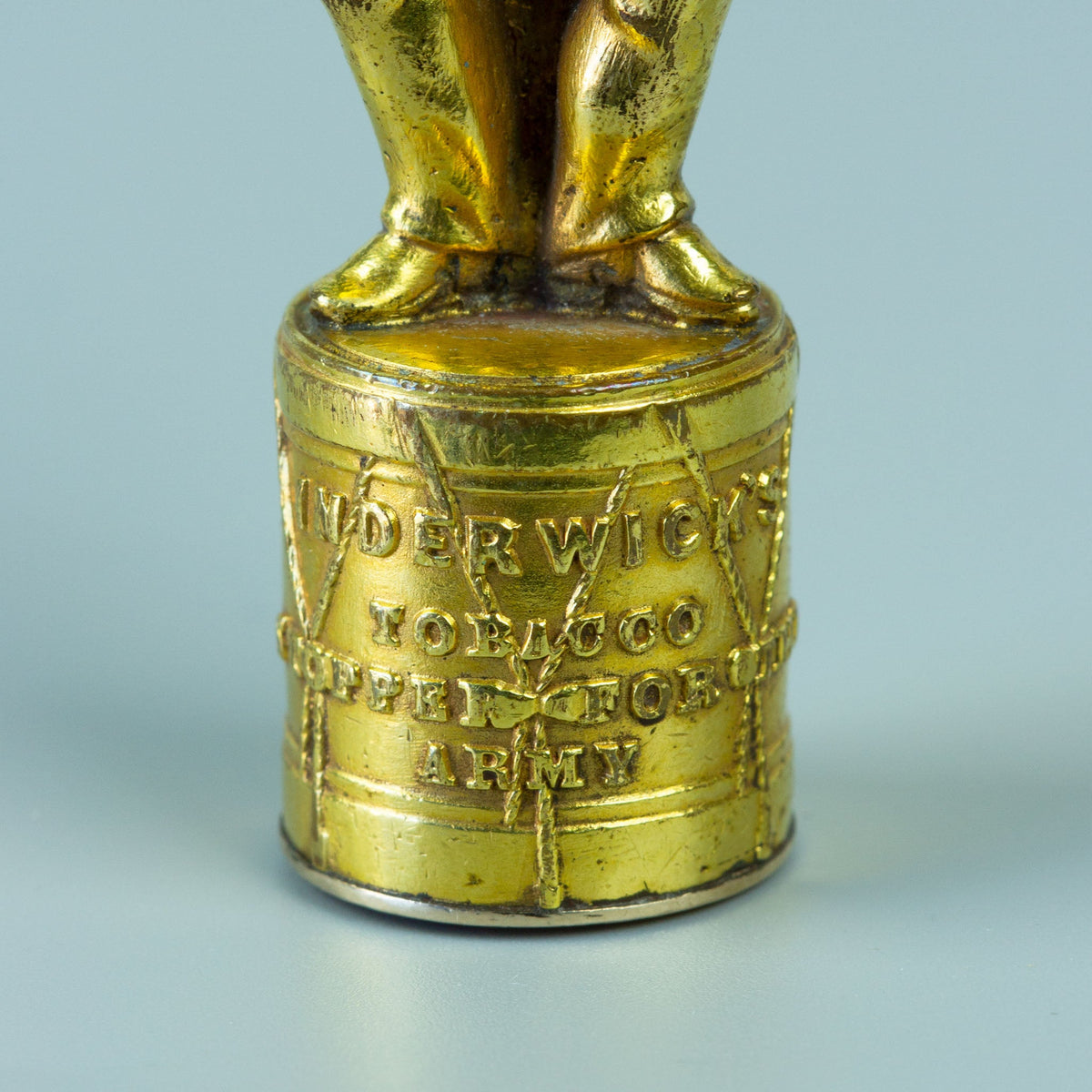 Closeup of gilt wax seal base in the form of a drum 