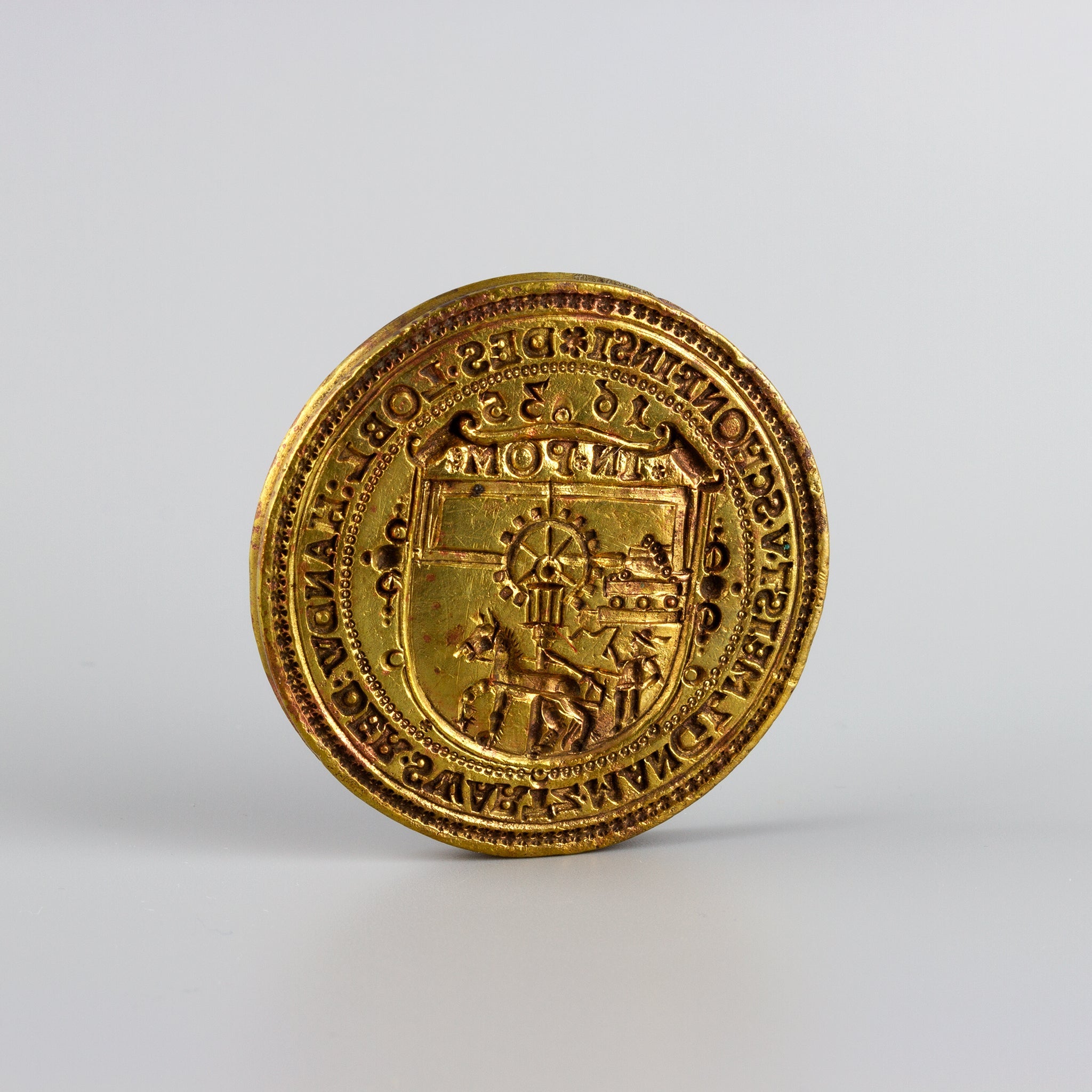 Closeup of wax seal engraved with horse and mill dated 1635 with circumscription