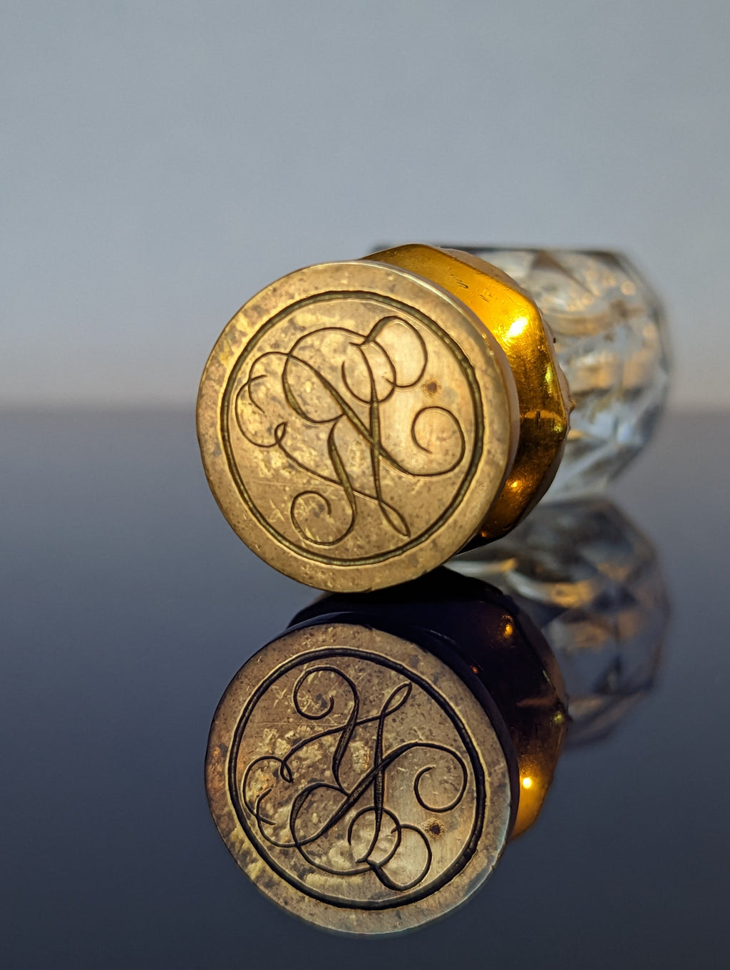 Detail of brass matrix with cypher on antique wax seal