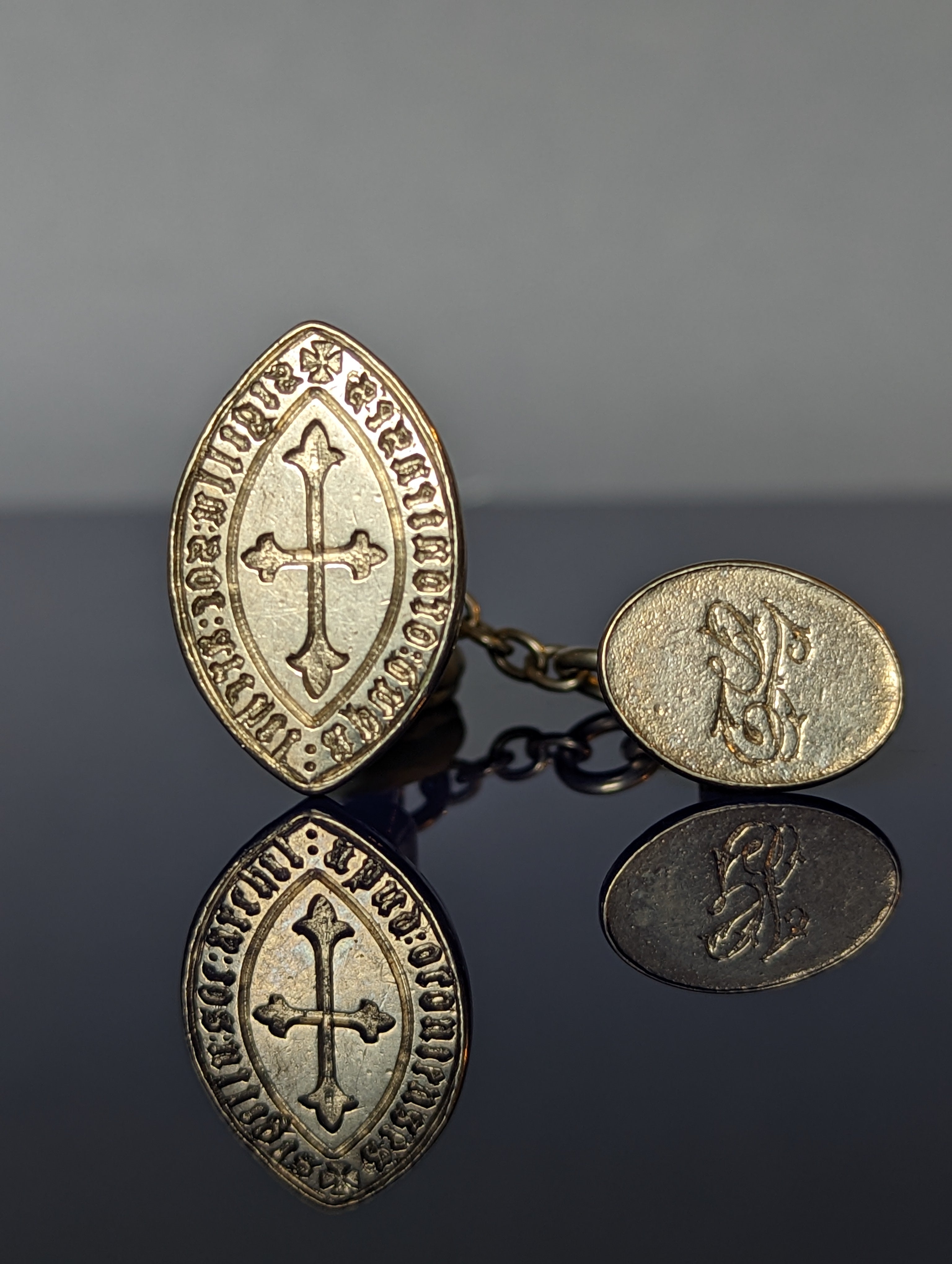 Closeup of silver fob wax seal with cross and inscription and second silver fob