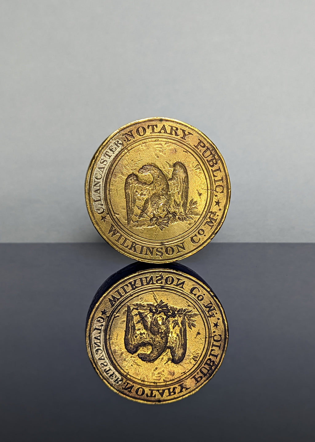 Circular brass wax seal matrix showing eagle and inscription 