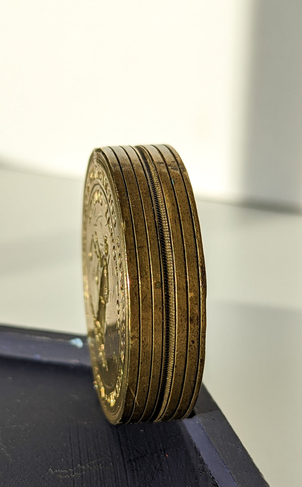 Antique American brass wax seal on its edge showing engraved bands
