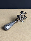Three quarter view of granite and steel spinning wheel desk seal