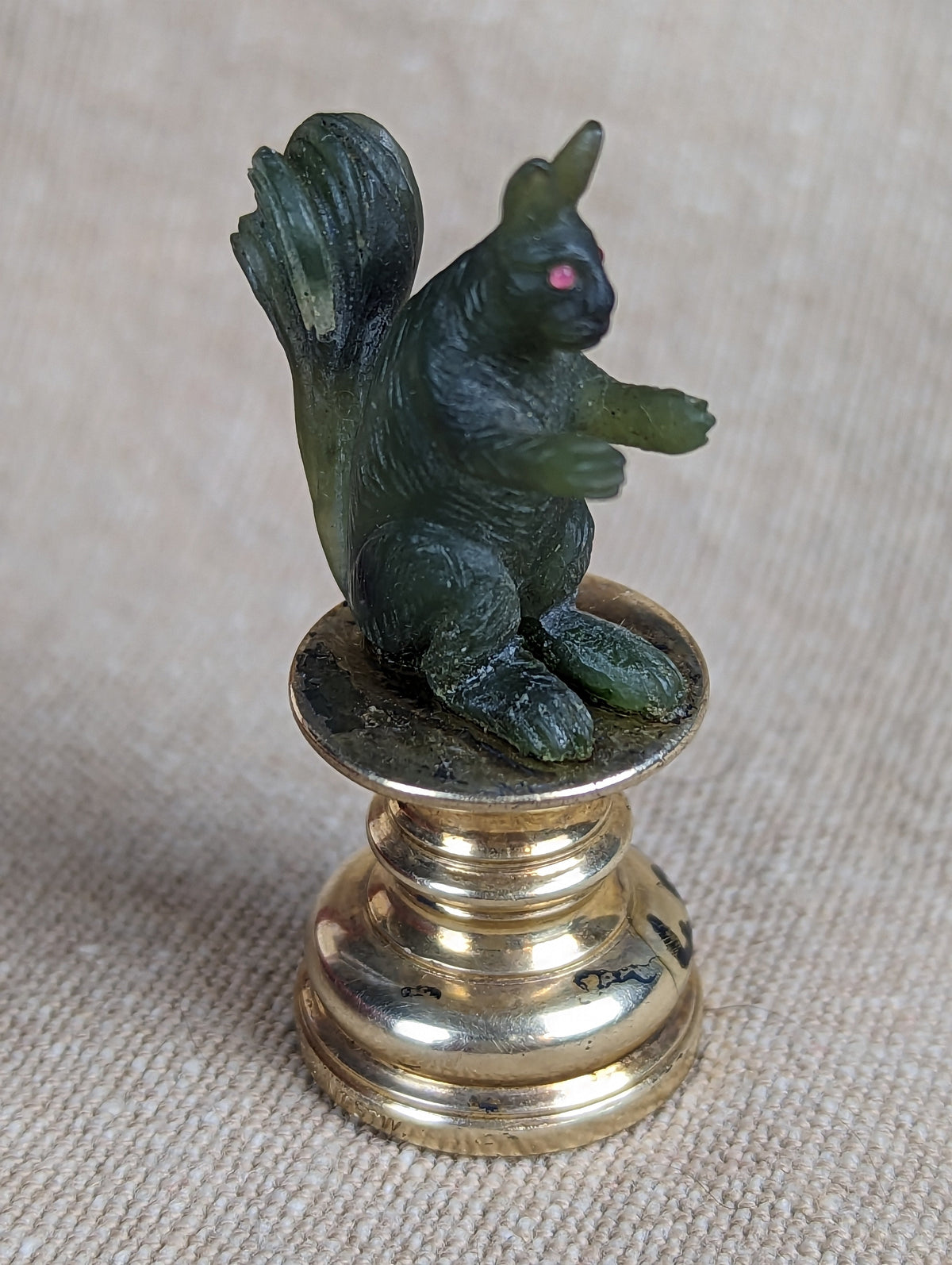 Close up of antique jade squirrel desk wax seal