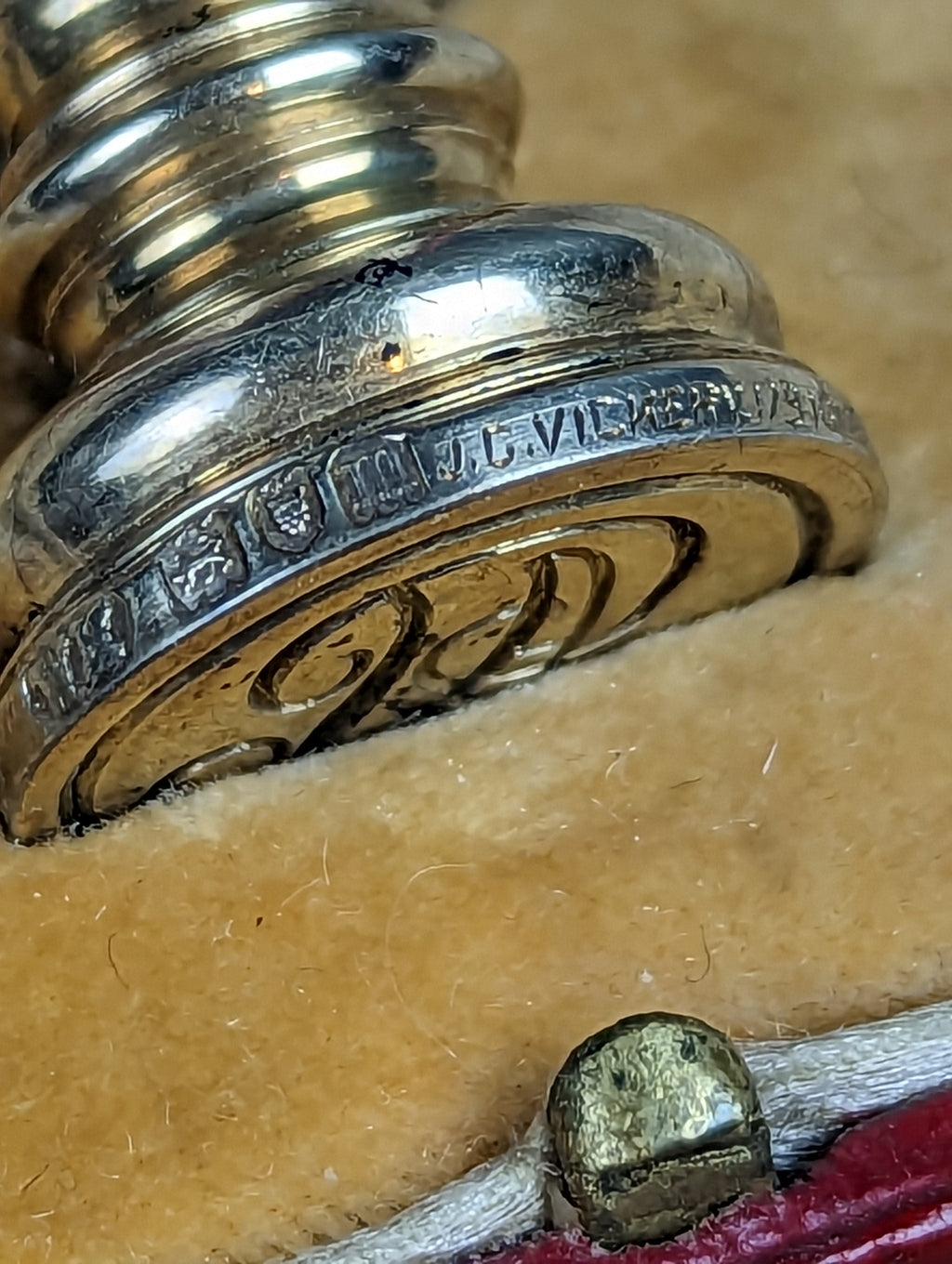 Engraved base of silver wax seal and red leather case