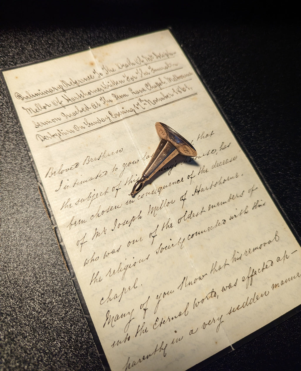Antique gold fob seal on old handwritten letter